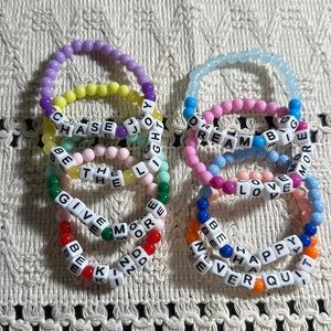 Stack of child beaded sayings bracelets